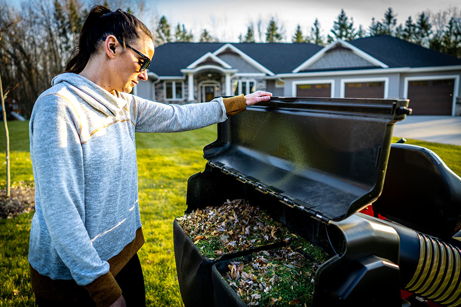 Fall scene including a bagger filled with leaves on an Ariens zero-turn lawn mower