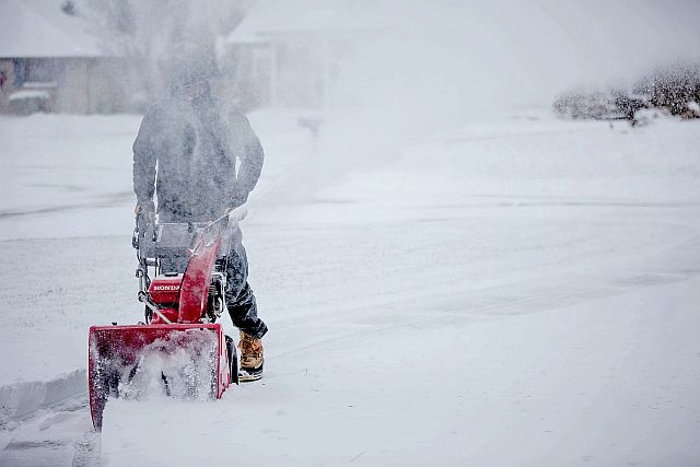person showing how snow blower works in snow